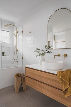 a bathroom with a sink, mirror and shower