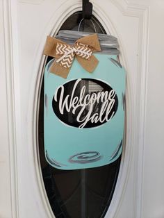 a welcome sign is hanging on the front door