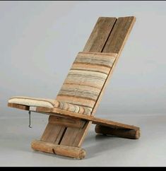 a chair made out of wooden planks sitting on top of a floor