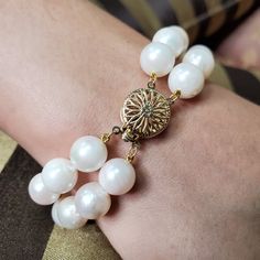 "Why wear one string when you can wear two?" Coco Chanel. You can never go wrong with a classic two strand pearl Bracelet!Large White ( some light pink overtone) Round, high-luster with typical natural blemishes Japanese Cultured pearls are double-knotted in this unforgettable piece, finished with a striking 14K Yellow gold clasp.Each pearl measures approx. 9-9.7mm in average with a total strands length of 7 inches. The weight 39.71gr.The 14k Yellow Gold ( stamped), Open Filigree Round Clasp is Japanese Pearls, Double Strand Necklace, Vintage Bracelet, Vintage Bracelets, Gold Pearl, Strand Necklace, Coco Chanel, Cultured Pearls, Large White