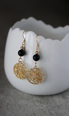 These beautiful geometric earrings was made of black matt onyx stone 8 mm beads, tiny gold tone czech glass beads, gold tone round charms and gold tone stainless steel earring hooks. Earring hooks are from nickel free and lead free metal. The total lenght of earrings is 60 mm including earring hooks. Other earrings of my shop you can see here: https://www.etsy.com/shop/NaTavelli?section_id=13757927 Thanks for visit! Black Gold-plated Pierced Earrings, Elegant Metal Beaded Earrings With Round Beads, Black Gold-plated Earrings, Black Gold-plated Earrings For Gift, Elegant Black Bead Earrings, Elegant Round Beaded Metal Earrings, Black Gold-plated Drop Earrings, Elegant Black Bead Drop Earrings, Elegant Adjustable Brass Beaded Earrings