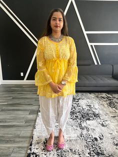 Introducing our exquisite Chikankari Kurti - a timeless masterpiece that beautifully weaves together the grace of traditional Indian craftsmanship and contemporary elegance. Handcrafted by skilled artisans, this kurti showcases intricate Chikankari embroidery, adding a touch of sophistication and charm to your wardrobe. Whether you're dressing up for a special occasion or looking for a chic yet comfortable outfit for everyday wear, our Chikankari Kurti is the perfect choice to effortlessly elevate your style and embrace the rich heritage of Indian fashion. Lucknowi hand embroidered chikankari kurti.  Detailed to perfection and measured to fit perfectly. This kurti will go perfectly with your traditional salwar, pant or palazzo. The material feels soft on your body and will keep the absorpt Designer Chikankari Embroidery Blouse For Eid, Traditional Tunic Sets With Dupatta, Yellow Long Sleeve Anarkali Set With Chikankari Embroidery, Designer Yellow Blouse For Eid, Transitional Yellow Chikankari Embroidery Salwar Kameez, Anarkali Tunic Sets With Chikankari Embroidery, Anarkali Chikankari Embroidery Tunic Set, Yellow Salwar Kameez With Chikankari Embroidery For Transitional Season, Transitional Season Yellow Salwar Kameez With Chikankari Embroidery