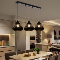 three lights hanging over a kitchen table in a room with chairs and counter top space