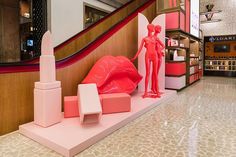 the interior of a store with mannequins and lipstick