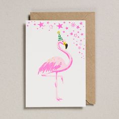 a card with a pink flamingo wearing a party hat