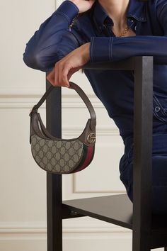 From the striped webbing and monogrammed canvas to the gold 'GG' hardware, this 'Ophidia' bag quite literally has Gucci written all over it. It's been crafted at the house's atelier in Italy and has an adjustable, belt-like shoulder strap. It unzips to reveal two handy card slots, as well as space for your phone and a few daily essentials. Gucci Ophidia Bag Outfit, Small Shoulder Bag Outfit, Mini Bag Outfit, Gucci Bag Outfit, Small Bags Fashion, Gucci Bags Handbags, Mini Designer Bags, Gucci Ophidia Bag, Gucci Ophidia