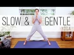 a woman standing on a yoga mat with the words slow & gentle in front of her