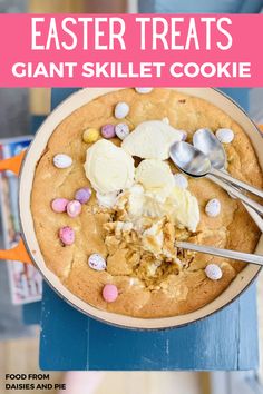 an easter treat in a bowl with spoons and candy on the side that says, easter treats giant skillet cookie