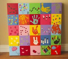 a colorful canvas with handprints on it in the shape of letters and numbers