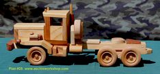 a wooden toy truck is shown on a blue surface with camouflage print wall behind it