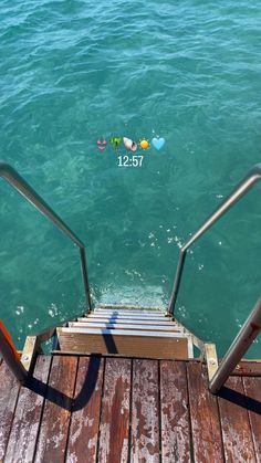 the stairs lead down to the water with hearts floating on them in the blue ocean