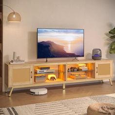 a flat screen tv sitting on top of a wooden entertainment center in a living room