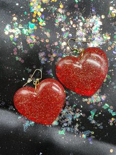 "Love Is In The Air! Big Red Heart Earrings!! Made from resin, red dye, fine white glitter, fine gold glitter and fine red glitter with gold split rings and gold fish hook findings. All connections are soldered for durability.  Earrings measure 2 1/2\" inch in drop length by about a 2\" inch in width." Cheap Red Heart Earrings, Cheap Red Glitter Earrings, Red Heart-shaped Earrings For Wedding, Red Resin Novelty Earrings, Red Heart-shaped Rhinestone Jewelry, Red Dye, Red Heart Earrings, Gold Fish, Split Rings