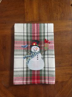 a plaid napkin with a snowman on it