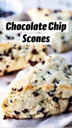 three scones with chocolate chips sitting on top of a towel