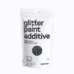 a bag of glitter paint sitting on top of a white table