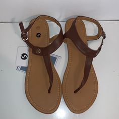 Rekayla Flat Thong Sandals With T-Strap And Adjustable Ankle Buckle For Women New Never Worn M3/B Adjustable Strappy T-strap Sandals In Synthetic, Adjustable Strappy Synthetic T-strap Sandals, Synthetic T-strap Sandals For Vacation, Summer Flat Adjustable T-strap Sandals, Adjustable T-strap Sandals In Synthetic Material, Summer Adjustable Flat T-strap Sandals, Beach T-strap Sandals With Adjustable Strap, Adjustable T-strap Sandals For Vacation, Casual Adjustable T-strap Sandals