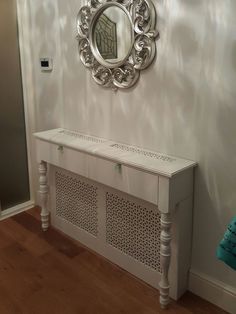 a white bench with a mirror on the wall