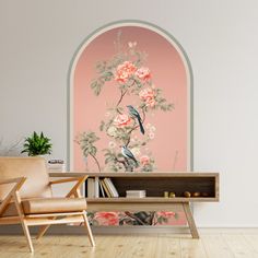 a room with a chair, book shelf and painting on the wall that has flowers in it