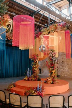 an arrangement of flowers and hanging decorations in a room