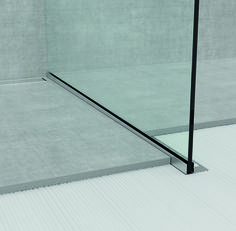 an empty shower stall with glass walls and floor