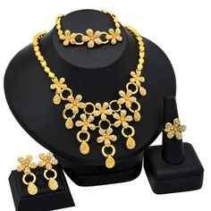 Indulge in luxury with this exquisite Necklace Set, perfect for wedding parties. With its opulent design and superior craftsmanship, this set features a necklace, bracelet, earrings, and ring. Make a lasting impression and elevate your style with this luxurious jewelry set." Elegant Alloy Jewelry Sets For Wedding, Wedding Jewelry Sets With Plated Cubic Zirconia, Wedding Cubic Zirconia Plated Jewelry Sets, Plated Alloy Jewelry Sets For Wedding, Wedding Alloy Plated Jewelry Sets, Wedding Jewelry Sets In Plated Alloy, Gold Crystal Bridal Necklace With Elegant Design, Yellow Gold Crystal Jewelry For Wedding, Gold Crystal Bridal Sets For Gift