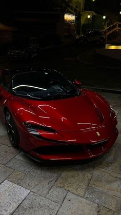 a red sports car parked in front of a building