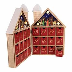 a wooden toy house with christmas decorations and numbers on the front, inside and out