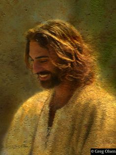 a man with long hair and beard smiling at the camera while wearing a white robe