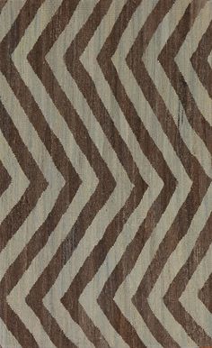 a brown and white area rug with wavy lines