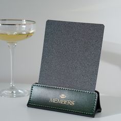 a card holder with a wine glass next to it