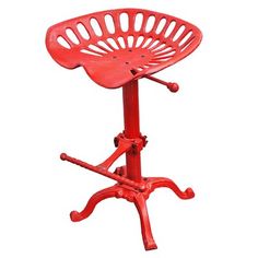 a red stool that is sitting up against a white background with the seat removed from it's base