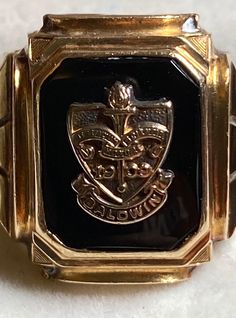 "A very vintage 10K yellow gold class ring for your consideration.  This bold ring is hallmarked 10k and guaranteed to be such. The maker's mark is also present and looks to be \"Deges &Clust\" The ring is from Baldwin College or School and dates back to 1909 according to the crest. I can't find creation dates to match. The black onyx center stone hold the crest of the school and heralds it's name.  The traditional graduation date of 1945 adorns the sides. The center stone measures approximately 12mm x 9.5mm.  The ring measures 16.7mm at its widest and tapers to 3.2mm in the back. It is a size 9 1/2 and weighs in at 6.7 grams. It's a great piece of history!" Classic 14k Stamped Signet Ring For Commemoration, Antique 14k Gold Signet Ring For Commemoration, Classic Hallmarked Signet Ring For Commemoration, Antique 14k Stamped Signet Ring For Commemoration, Classic 14k Gold Engraved Ring For Commemoration, Classic Signet Ring For Commemoration, Classic Gold Engraved Memorial Ring, Classic Gold Engraved Ring For Memorial, Classic Engraved Ring Stamped 14k For Commemoration