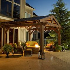 a covered patio area with furniture and lights