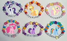 four pony bracelets with name tags on them