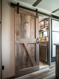 an open sliding barn door in a kitchen