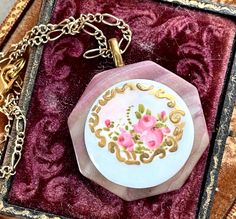 This lovely hand painted antique porcelain stud button has been set upon a vintage mother of pearl buckle to create this simply lovely pendant necklace.  These were produced in the 1800's  and early 1900's, painted by hand, some as cottage industries.   I work with antique and vintage parts. Some may show signs of wear or age. Please look at each picture closely. I have tried to show all aspects of my work. Please contact me before purchasing if you have any questions or would like more clarity Vintage Hand-painted Pendant Necklace, Vintage Hand Painted Pendant Necklace, Vintage Enamel Flower Pendant Jewelry, Vintage Enamel Necklace With Large Pendant, Vintage Pink Necklace For Mother's Day, Vintage Hand Painted Necklace As Gift, Vintage Hand Painted Necklaces For Gift, Hand Painted Vintage Necklace As Gift, Hand Painted Vintage Necklace For Gift