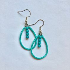 These handmade, beaded teardrop shaped earrings come in a variety of colors. this pair is A teal turquoise color. Perfect for all occasions and super comfortable to wear. These earrings are not heavy at all and can be worn comfortably all day. The earrings are 2 cm across. Every pair is unique and  may look somewhat different than the picture. I love making these earrings and hope you enjoy wearing them! Turquoise Teardrop Earrings With Tiny Beads, Turquoise Teardrop Beaded Earrings As Gift, Turquoise Teardrop Beaded Earrings For Gifts, Dangle Teardrop Earrings With Tiny Beads, Green Teardrop Earrings With Tiny Beads, Bohemian Beaded Turquoise Teardrop Earrings, Bohemian Turquoise Beaded Teardrop Earrings, Bohemian Turquoise Teardrop Beaded Earrings, Turquoise Teardrop Beaded Bohemian Earrings