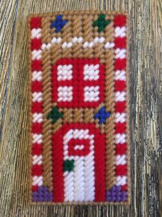 a close up of a piece of knitted material on a wooden table with wood flooring