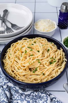 a bowl of pasta with parsley on the side