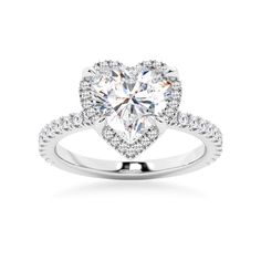 a heart shaped diamond ring with diamonds on the band and an open halo setting in white gold