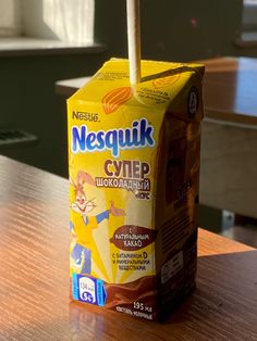 a carton of milk sitting on top of a wooden table