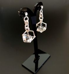 Unusual, sparkly diamond shaped crystals are captured in silver plated cages. I have joined them to the crystal, non allergenic, stainless steel posts with chain maille. Nice neutral earrings will go with anything. Makes a lovely gift. Here is a link to my whole shop: https://www.etsy.com/shop/designsbymalone RETURNS - BUY WITH CONFIDENCE Don't worry, I will refund or exchange an item up to 60 days. Makes gift giving easy! All my items will arrive in a gift box and/or a velvet or organza pouch. Modern Silver Crystal Earrings For Evening, Single Crystal Earring As A Gift, Party Earrings With Clear Metal, Clear Pierced Jewelry For Party, Modern Silver Dangle Crystal Earrings, Modern Silver Crystal Earrings, Silver Diamond-shaped Earrings For Gift, Modern Silver Metal Crystal Earrings, Silver Pierced Crystal Earrings For Party