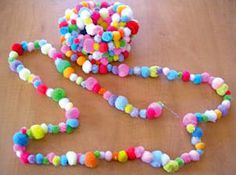 a multicolored beaded necklace on a wooden table