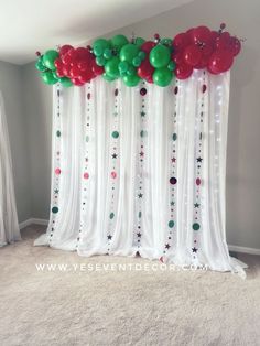 balloons and streamers are hanging from the curtain in front of an empty room with carpet