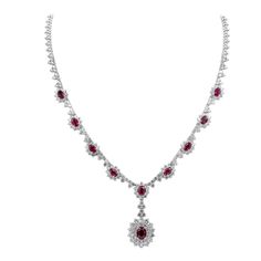 An elegant necklace, showcasing a drop pendant with a 1.30 carats oval cut ruby, surrounded by two rows of round brilliant cut diamonds. Accented by even more oval cut rubies surrounded by round brilliant cut diamond halos. Accent rubies weigh 4.63 carats total, and diamonds weigh 7.98 carats total. Finely made with 18K white gold. Roman Malakov is a custom house, specializing in creating anything you can imagine. If you would like to receive a special quote on a custom piece, please message or Money And Jewelry, Diamond Drop Necklace, Ruby Set, White Gold Pendant Necklace, Gold Money, Halo Necklace, Vintage Fine Jewelry, Halo Design, Chic Necklace