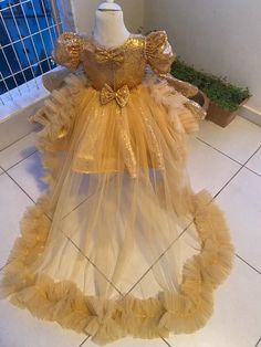 ✨Gold Princess Tutu Dress - The Shiny Star of Any Party!✨ Hey, parentals! Looking to sprinkle a bit of pixie dust on your little one's special day? Enter the Gold Princess Tutu Dress - your ticket to transforming her into the belle of the ball or any festivity! 💃🏼 ✨ This dazzling gold frock sparkles brighter than a starry night and is perfect for your birthday queen, flower girl duties, or any "just because" celebration. The twirly tutu skirt with a swoon-worthy train adds an extra dash of fla Gold Fitted Princess Dress For Birthday, Gold Princess Dress With Ruffles, Gold Princess Tutu Dress With Ruffles, Princess Gold Tutu Dress With Ruffles, Princess Style Gold Tutu Dress With Ruffles, Gold Ruffled Tutu Dress For Pageant, Gold Ruffled Tutu Dress For Pageants, Gold Tulle Princess Dress For Birthday, Gold Party Outfit