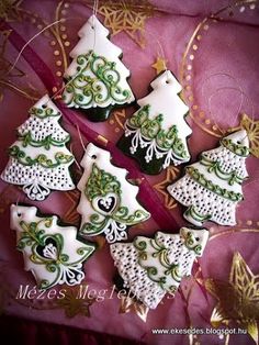 decorated cookies are arranged in the shape of christmas trees