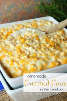 homemade creamed corn in the crockpot is ready to be eaten with a wooden spoon