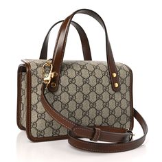 This is an authentic GUCCI GG Supreme Monogram Azalea Calfskin Mini Horsebit 1955 Foldover Top Handle Bag in Beige, Ebony, and Brown Sugar. This stylish shoulder bag is crafted of classic Gucci monogram GG supreme canvas with brown leather trim. The bag features leather handles, optional leather shoulder strap, and gold horse-bit detail. The top flaps open to a beige fabric interior with elastic pockets. Gold Horse, Gucci Monogram, Horse Bits, Stylish Shoulder Bag, Beige Fabric, Leather Handles, Handle Bag, Leather Trim, Leather Handle